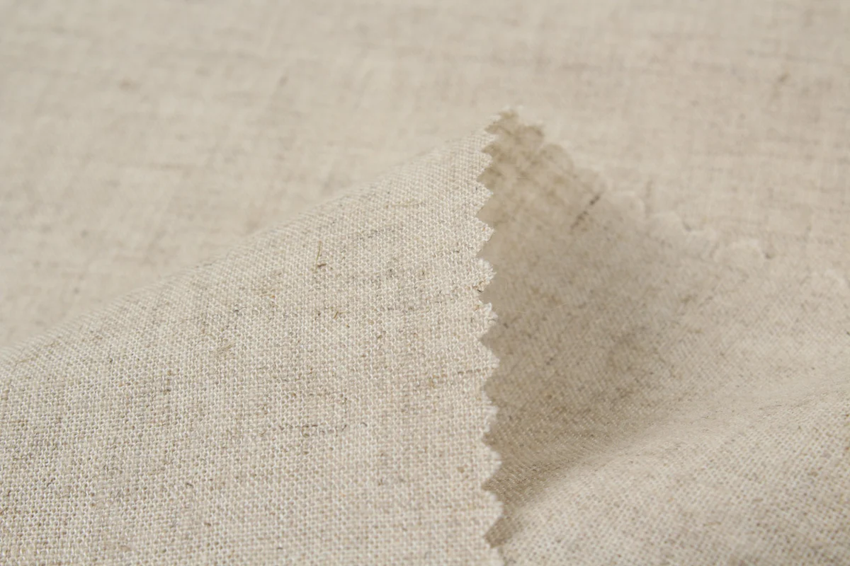 Assorted dried herbal blend ingredients laid on natural linen fabric